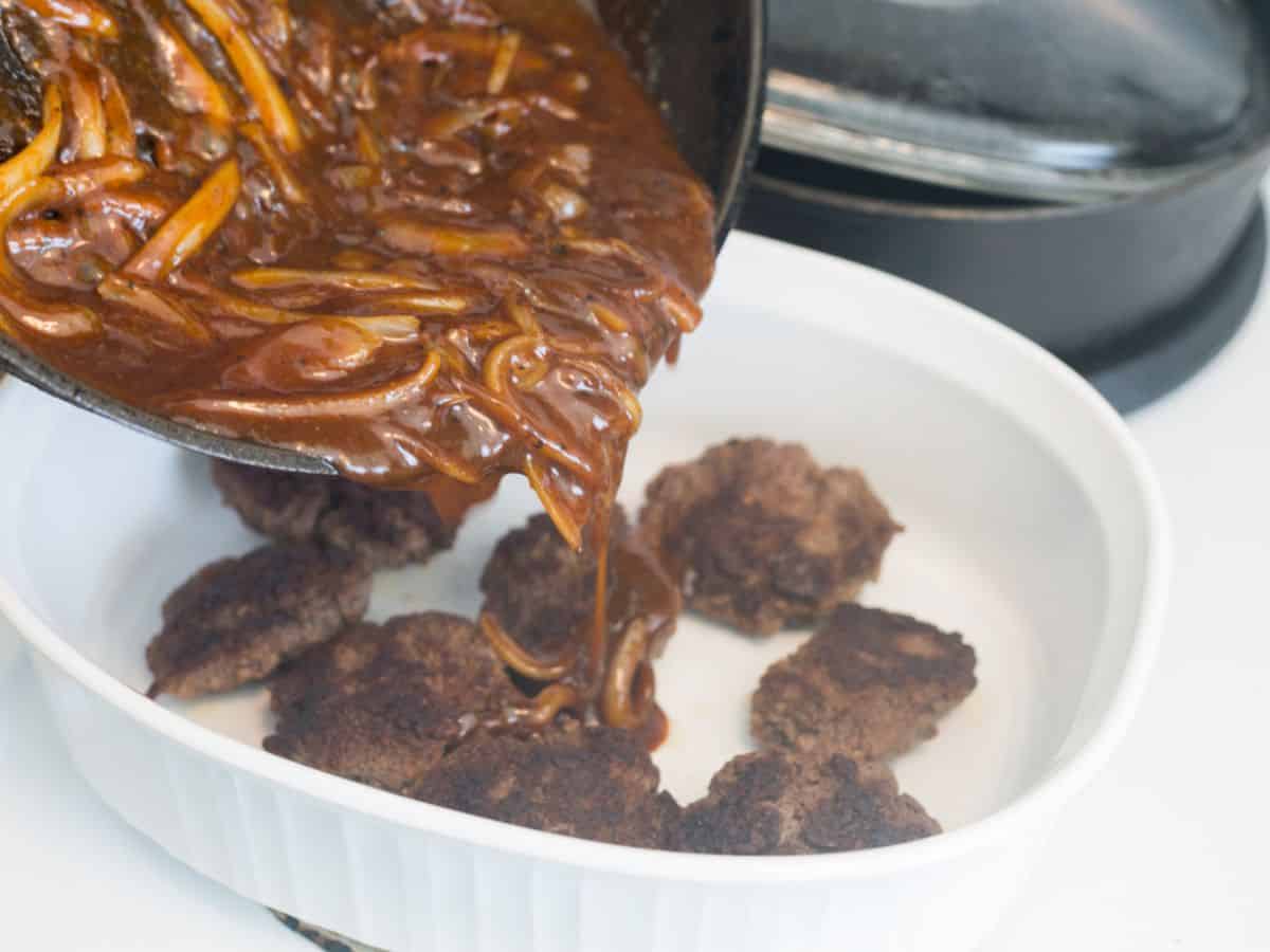 onion bbq sauce pouring over beef patties