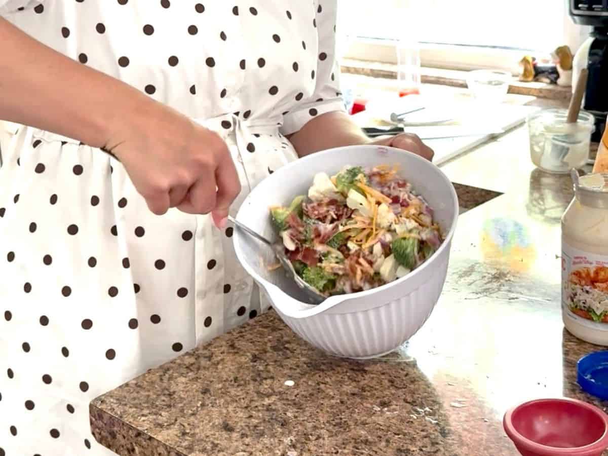 stirring bowl of salad.