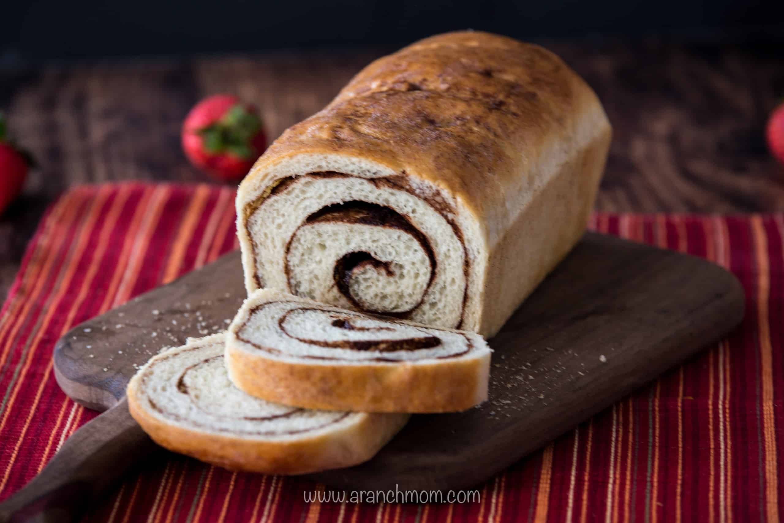 Baked Cinnamon Bread on cutting board, slices cut