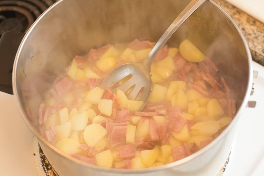 potatoes and ham simmering in water