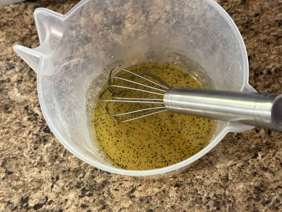 salad dressing in small bowl with whisk.
