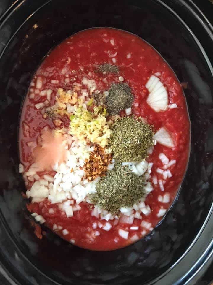 crushed tomamtoes and spices in crockpot