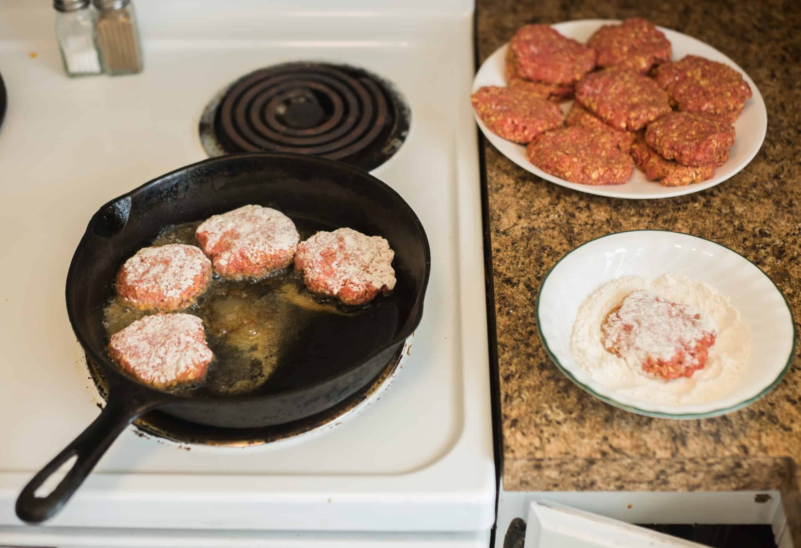 meat patties frying in oil