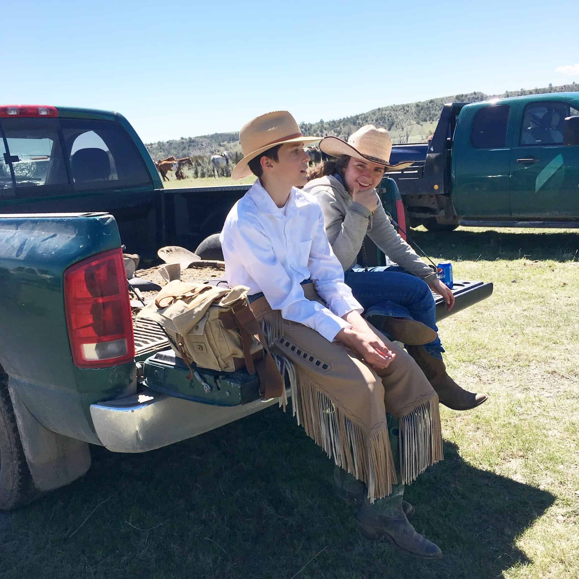 ranch kids sitting on tailgate