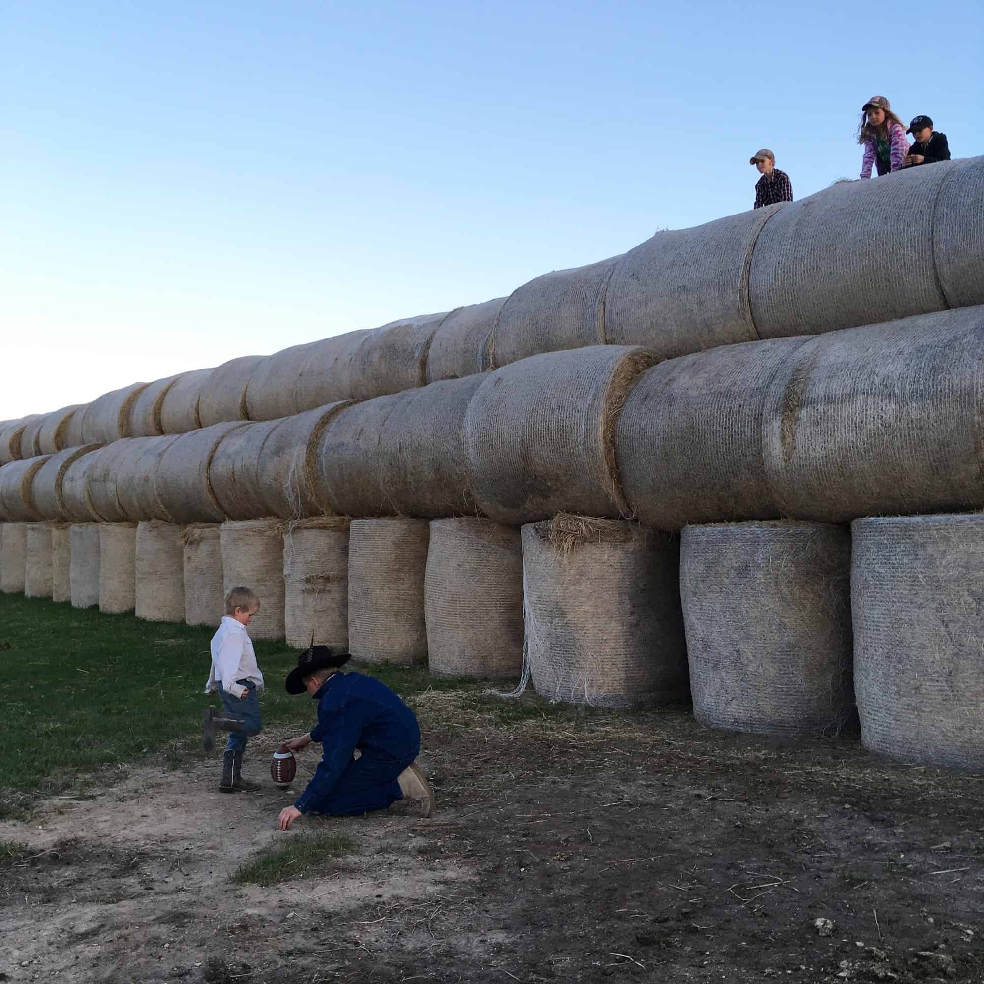 kids playing on hay bales 