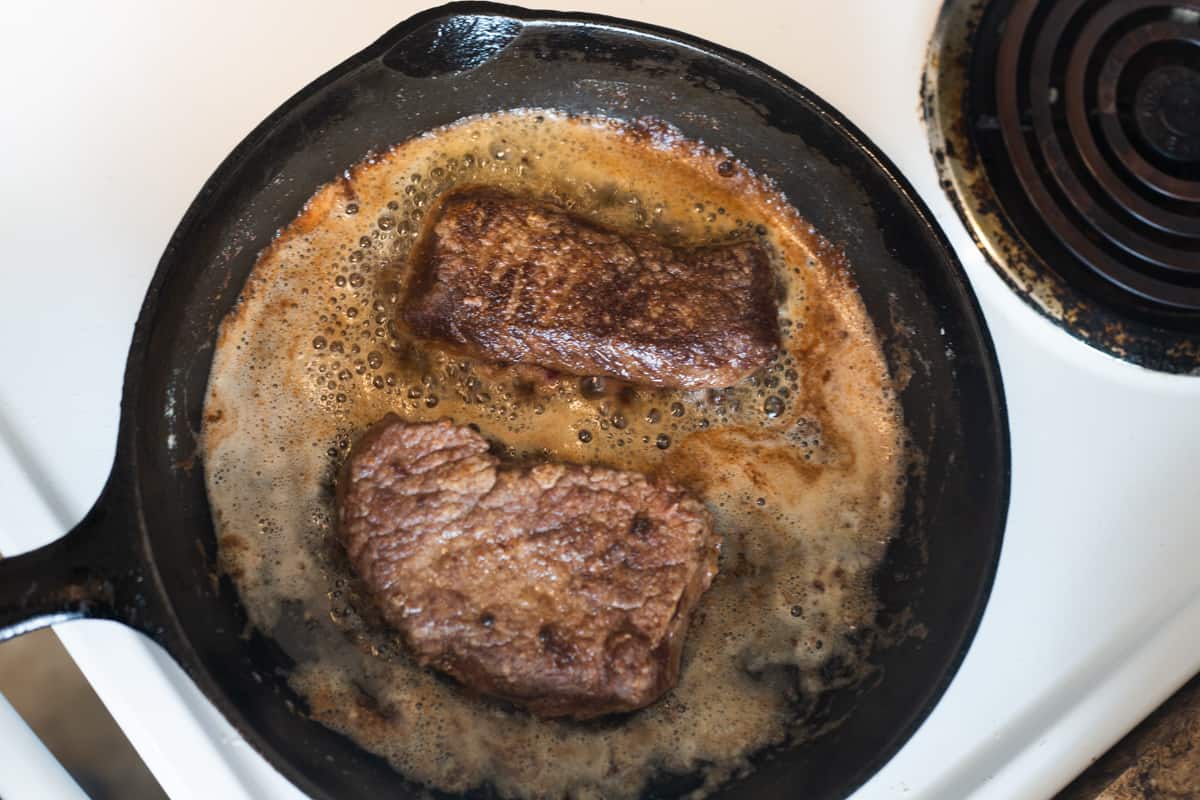 deer steak frying in oil