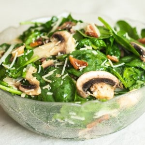 spinach mushroom salad in glass bowl