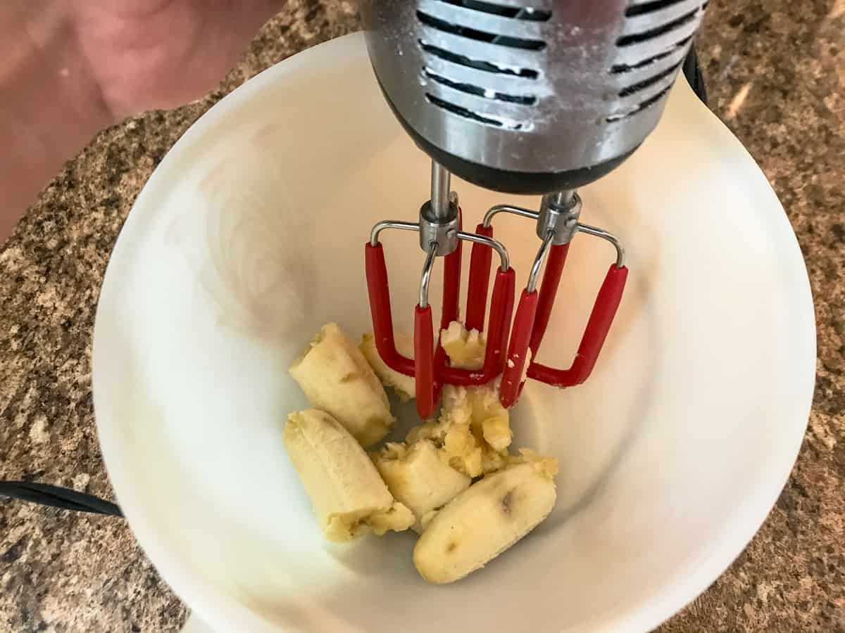 bananas in bowl with mixer nearby