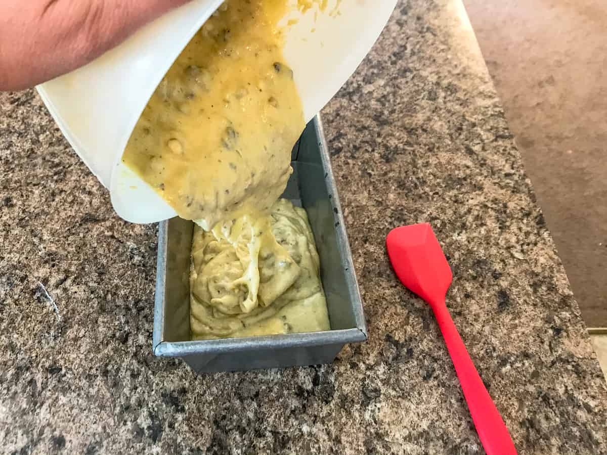 banana bread batter pouring into pan