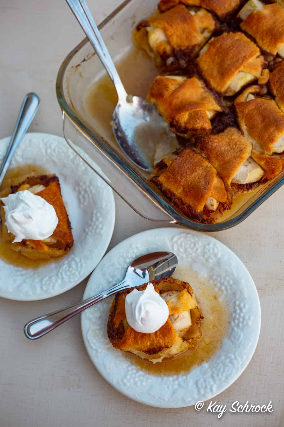 Apple dumplings in pan and small plates , ready to serve