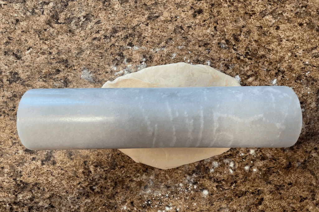 rolling pin on ball of tortilla dough 
