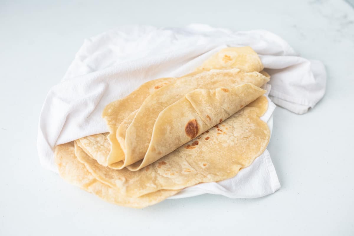 homemade tortillas in white towel