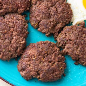 sausage patties on a blue plate.
