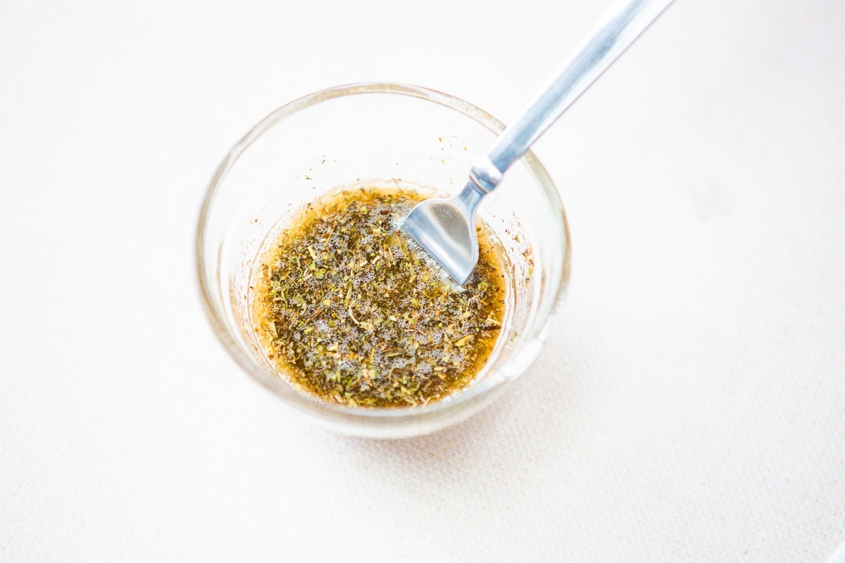 Seasonings and melted bacon fat in a dish.