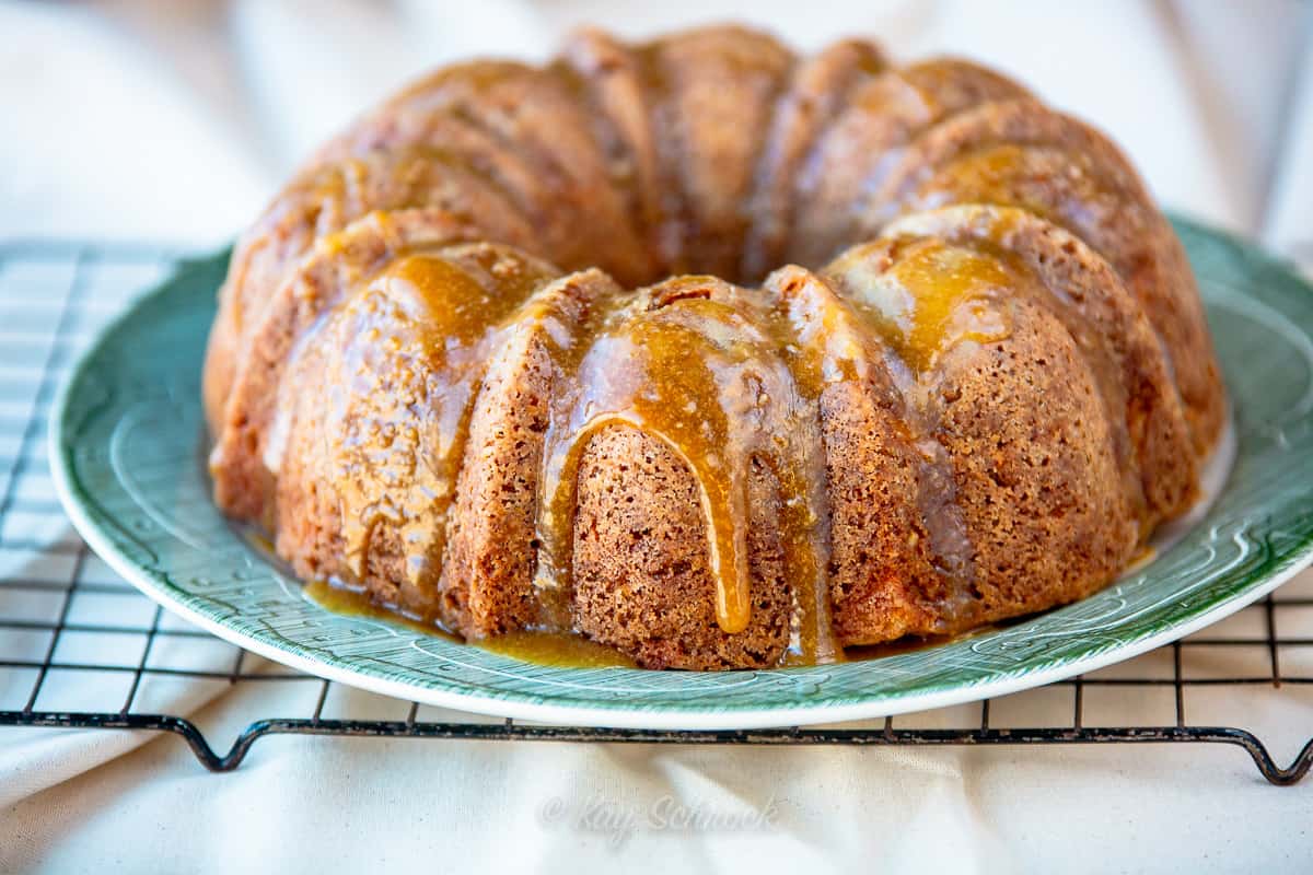 apple cake with caramel sauce dripping down sides