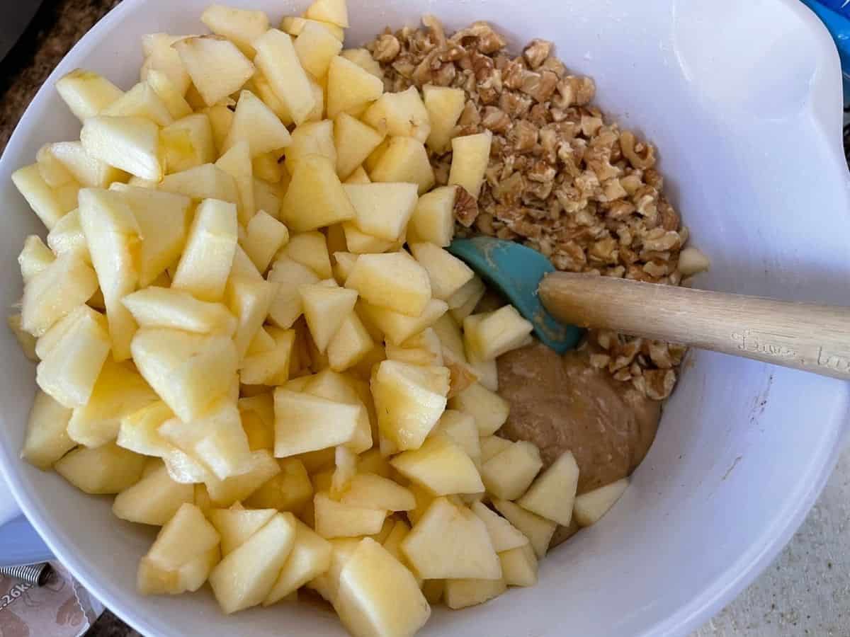 chopped apples and nuts in mixing bowl