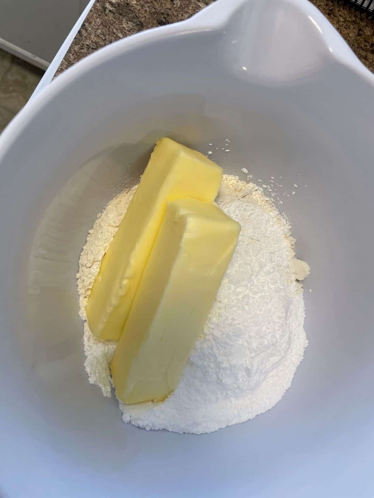 butter sticks and flour in mixing bowl 