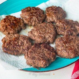 Venison sausage patties on a blue plate