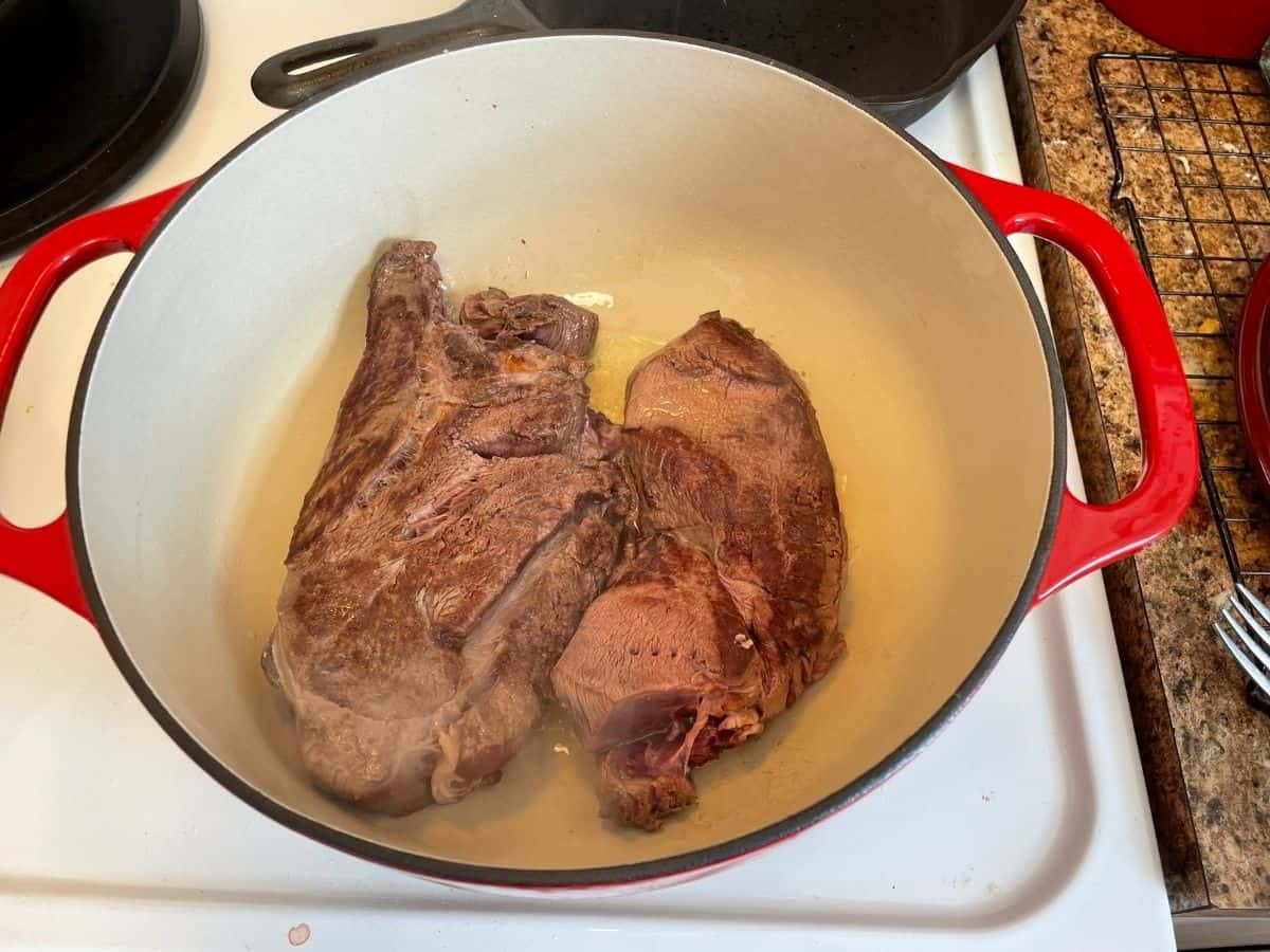 elk roast searing in red dutch oven