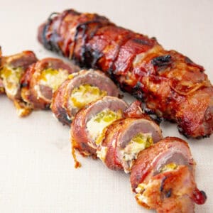 bacon-wrapped venison tenderloin, sliced.