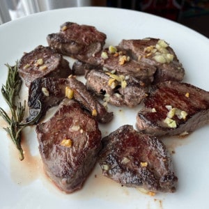 Pan Seared Venison Backstrap on a white plate