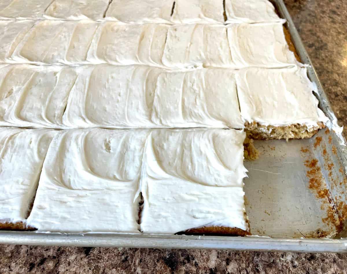 frosted and sliced banana cake in pan