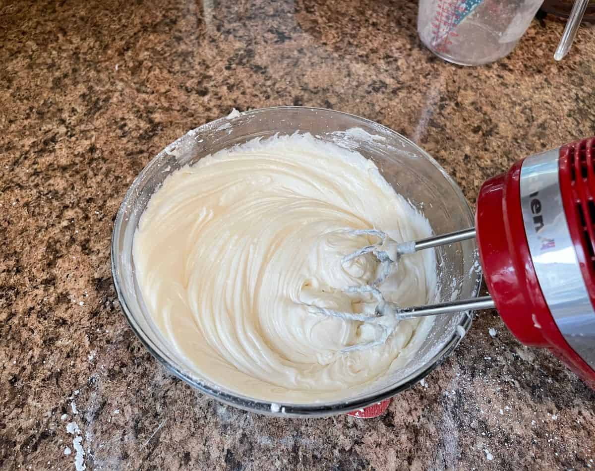 cream cheese frosting in white bowl