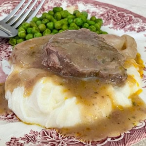 elk roast with gravy over mashed potatoes