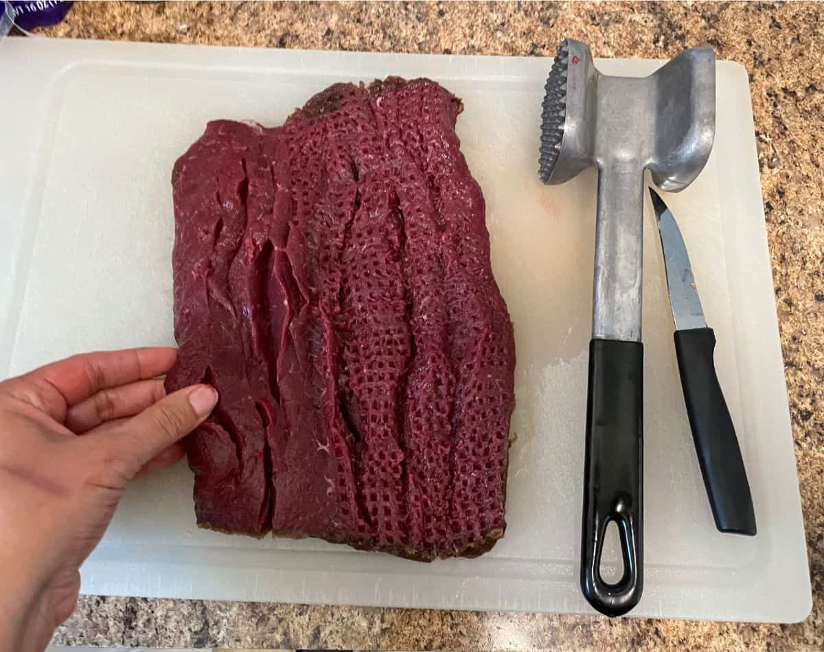 using a meat mallet to flatten the loin