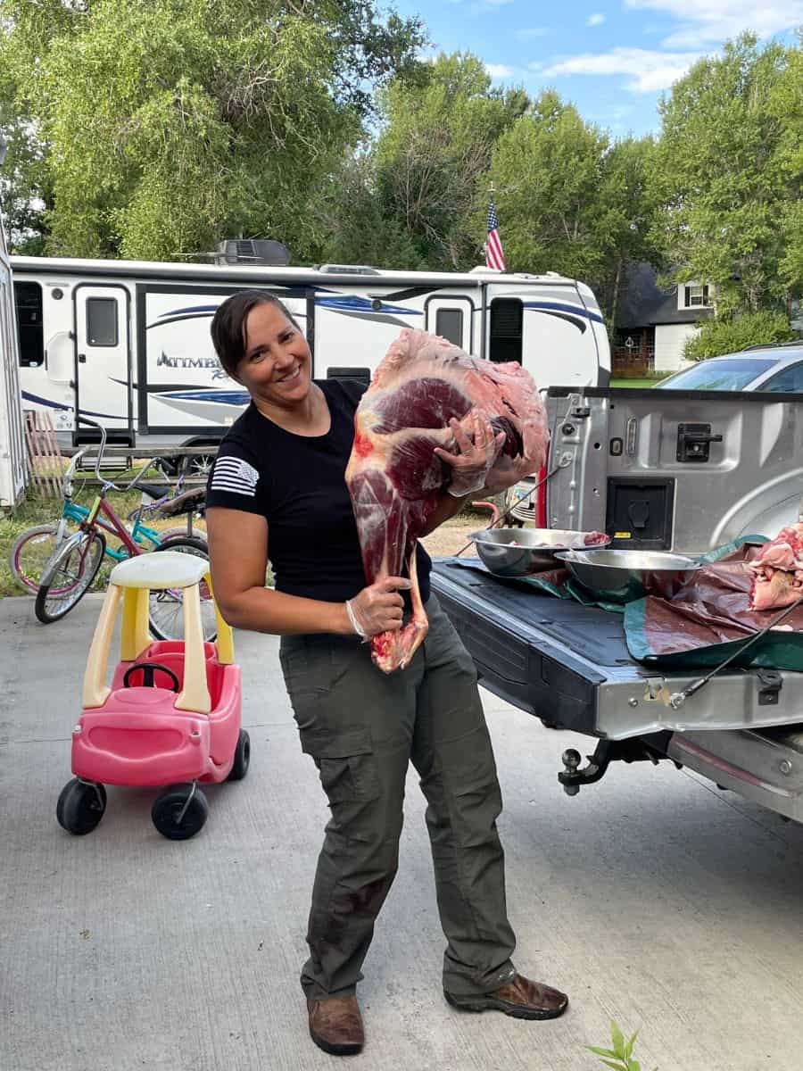 woman holding elk hindquarter