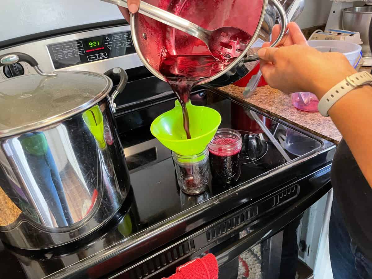 pouring jelly into jars
