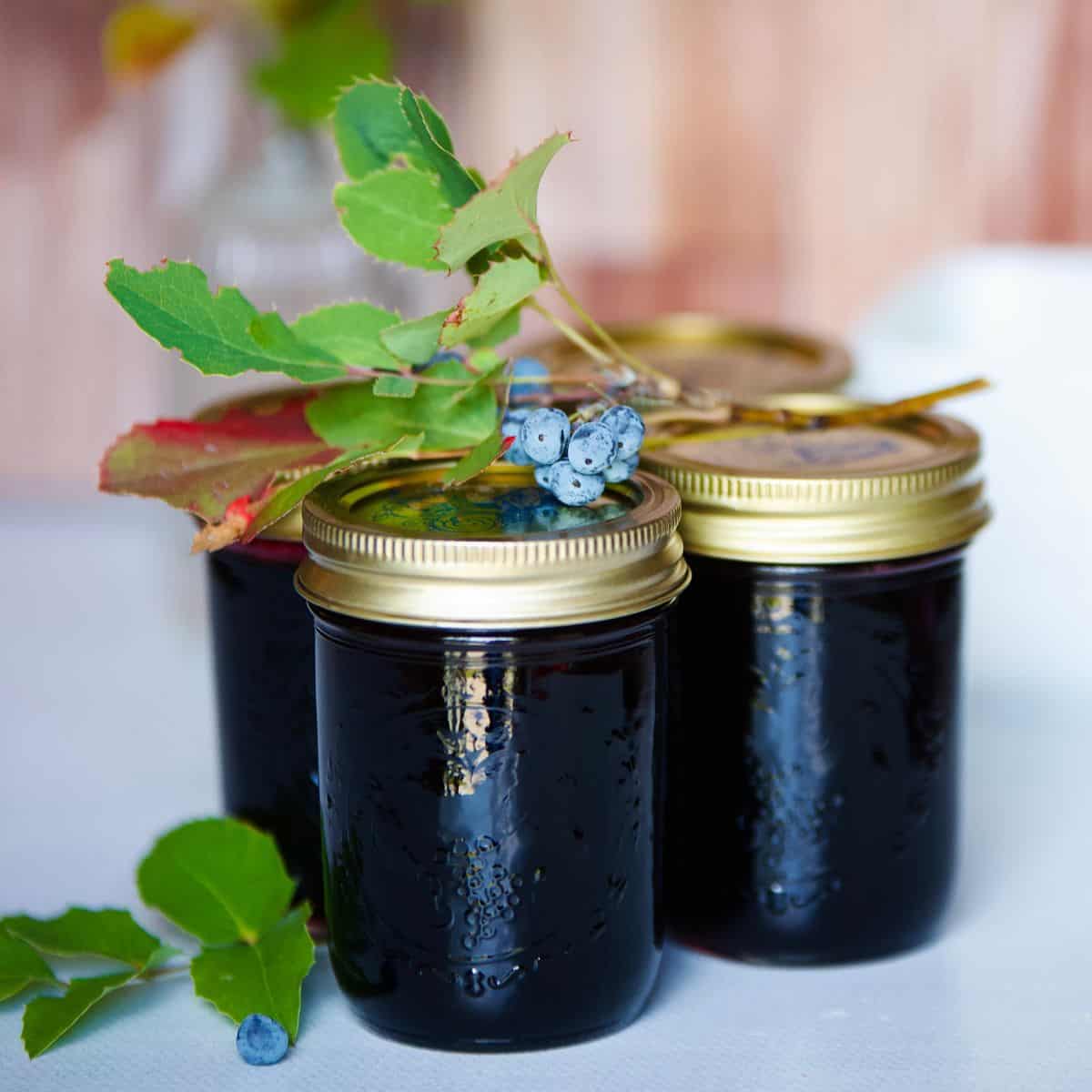 jars of jelly with leaves and berries