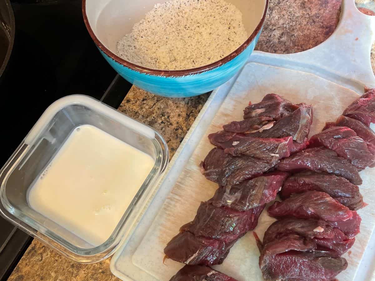 venison tenderloin sliced on cutting board